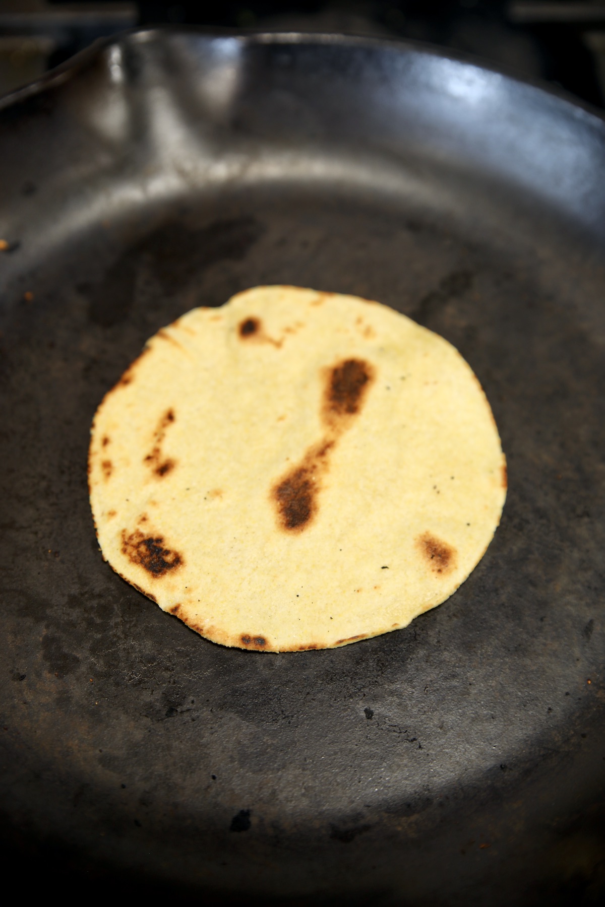 Cooking tortilla in a skillet.