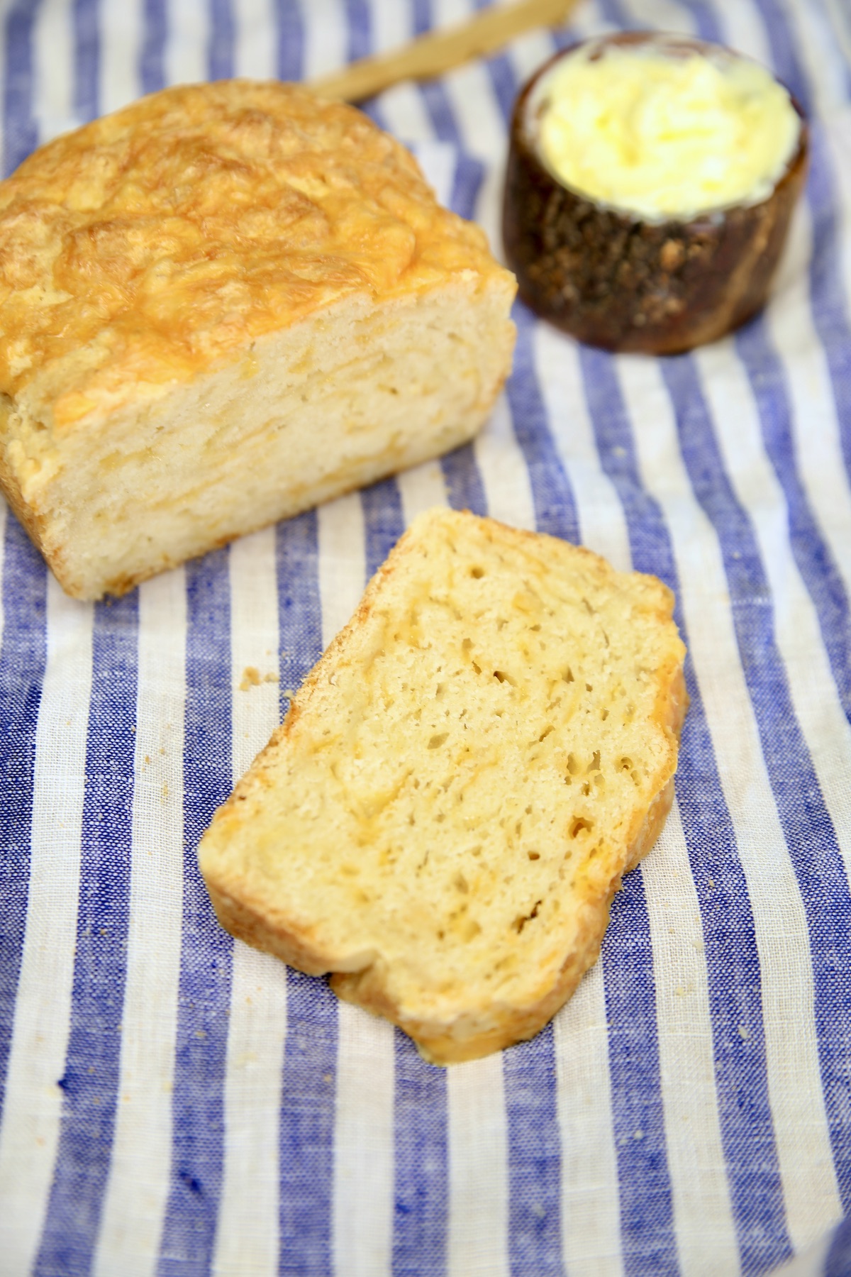 Beer cheese bread with a slice and butter.