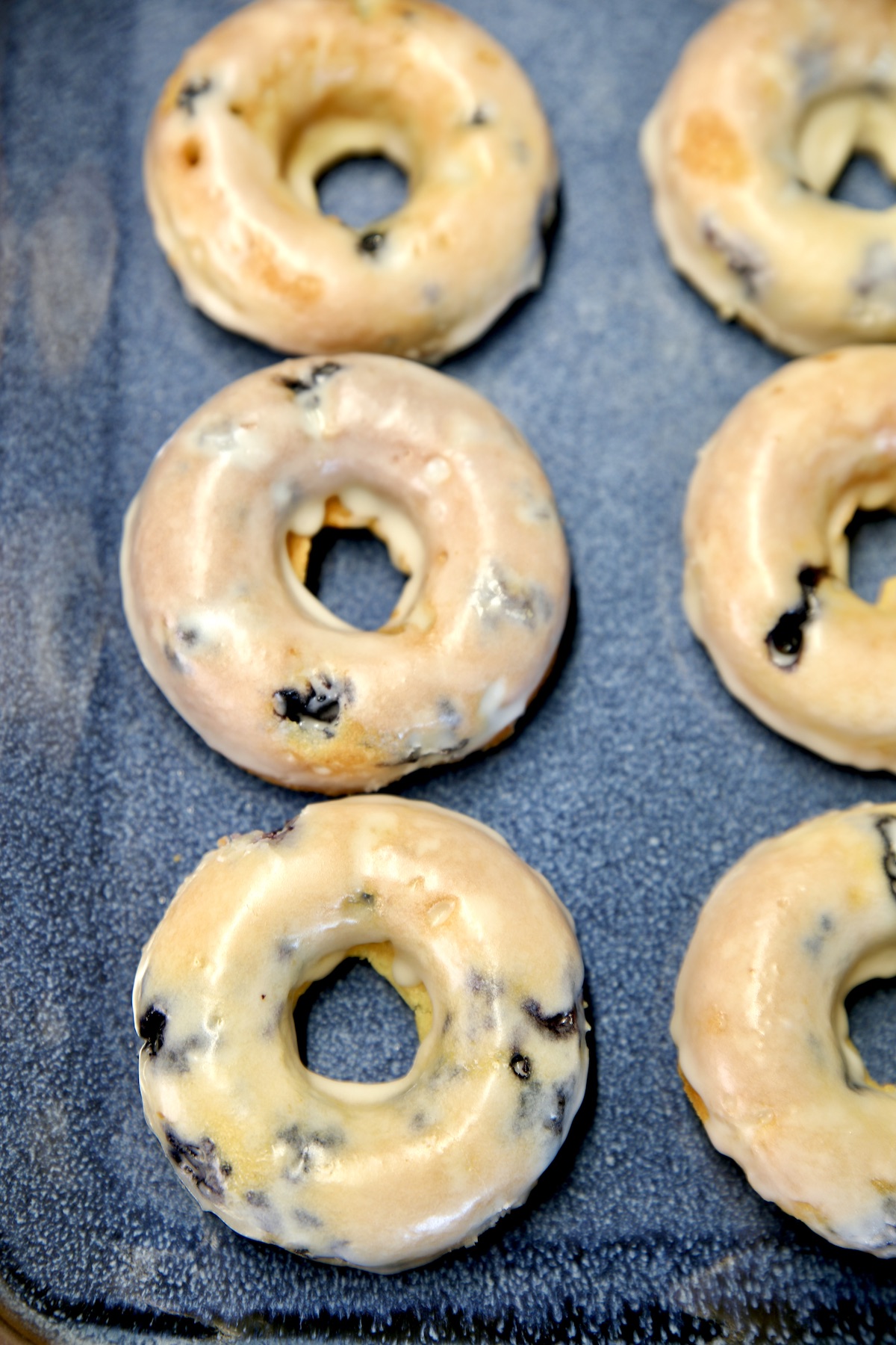 Platter of blueberry donuts.