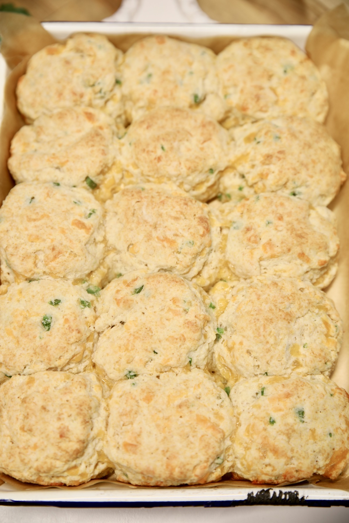 Baked jalapeno cheddar biscuits in a pan.