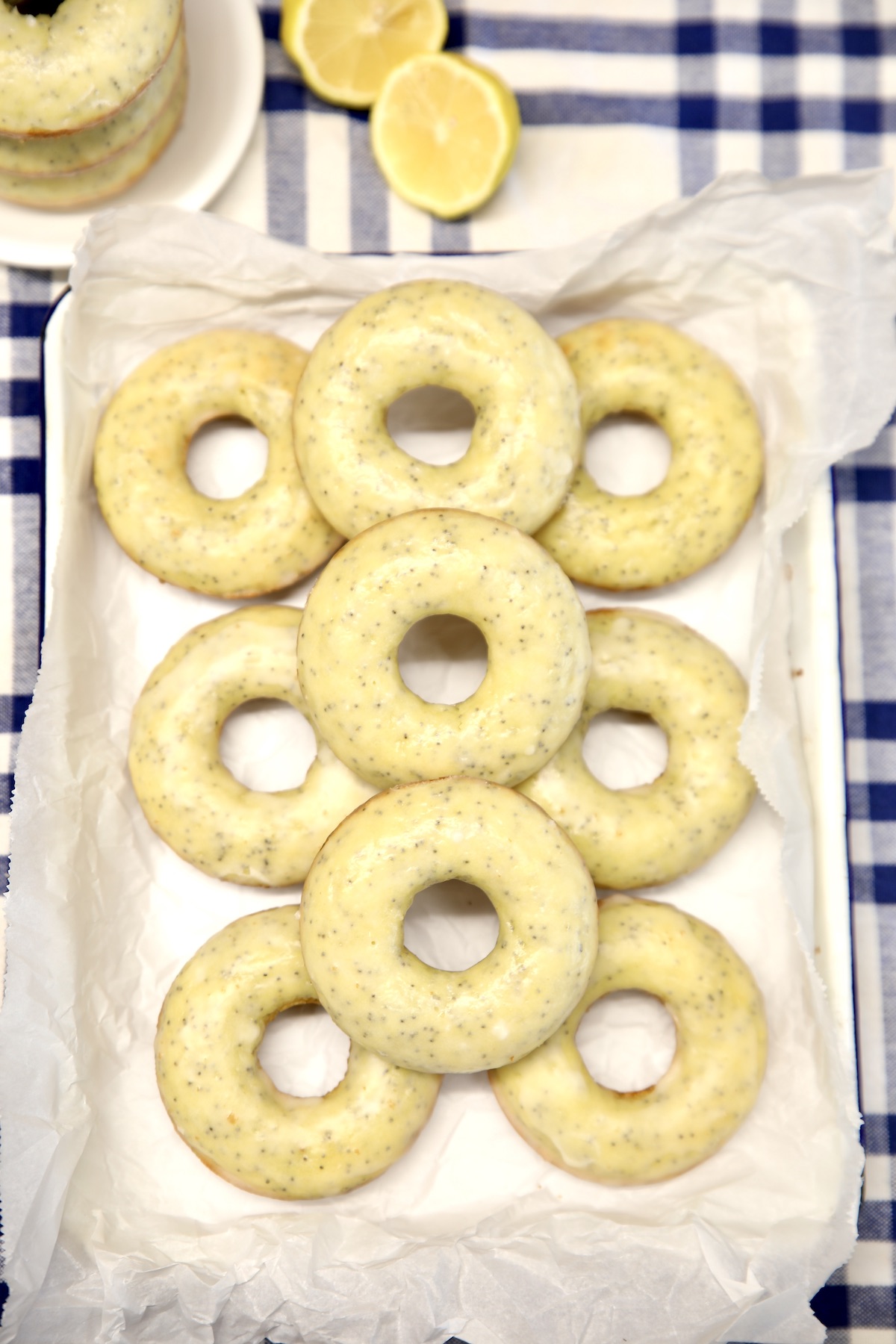 Lemon poppy seed donuts on a tray.