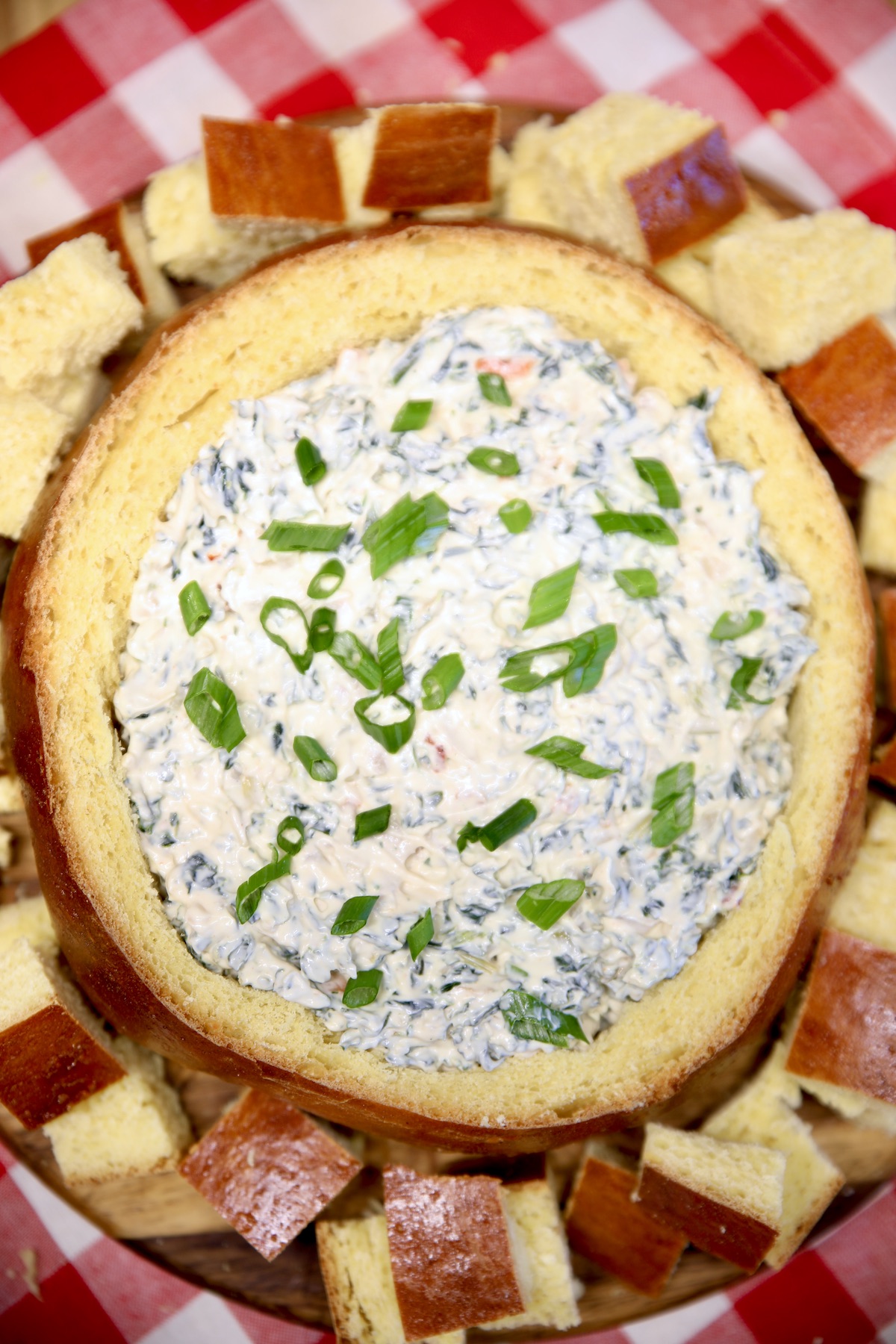 Bread bowl filled with spinach dip.