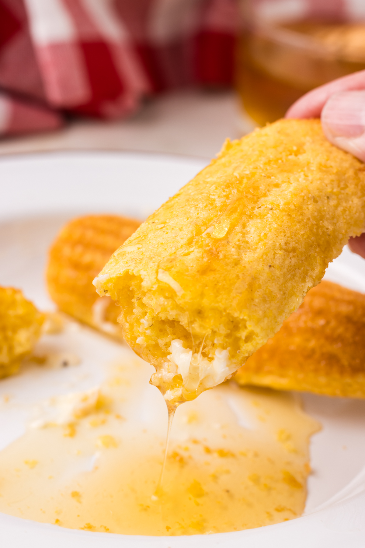 Fresh cornbread stick dipped in warm butter and honey.