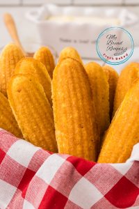 Fresh out of the oven cornbread sticks in a basket.