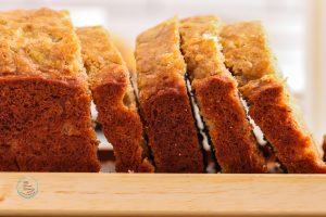 Sliced banana bread on a cutting board.