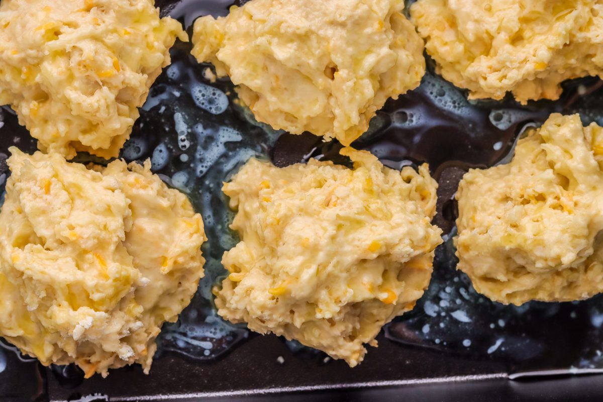 biscuit dough balls lined a baking sheet six drop biscuit dough balls lined on a baking sheet