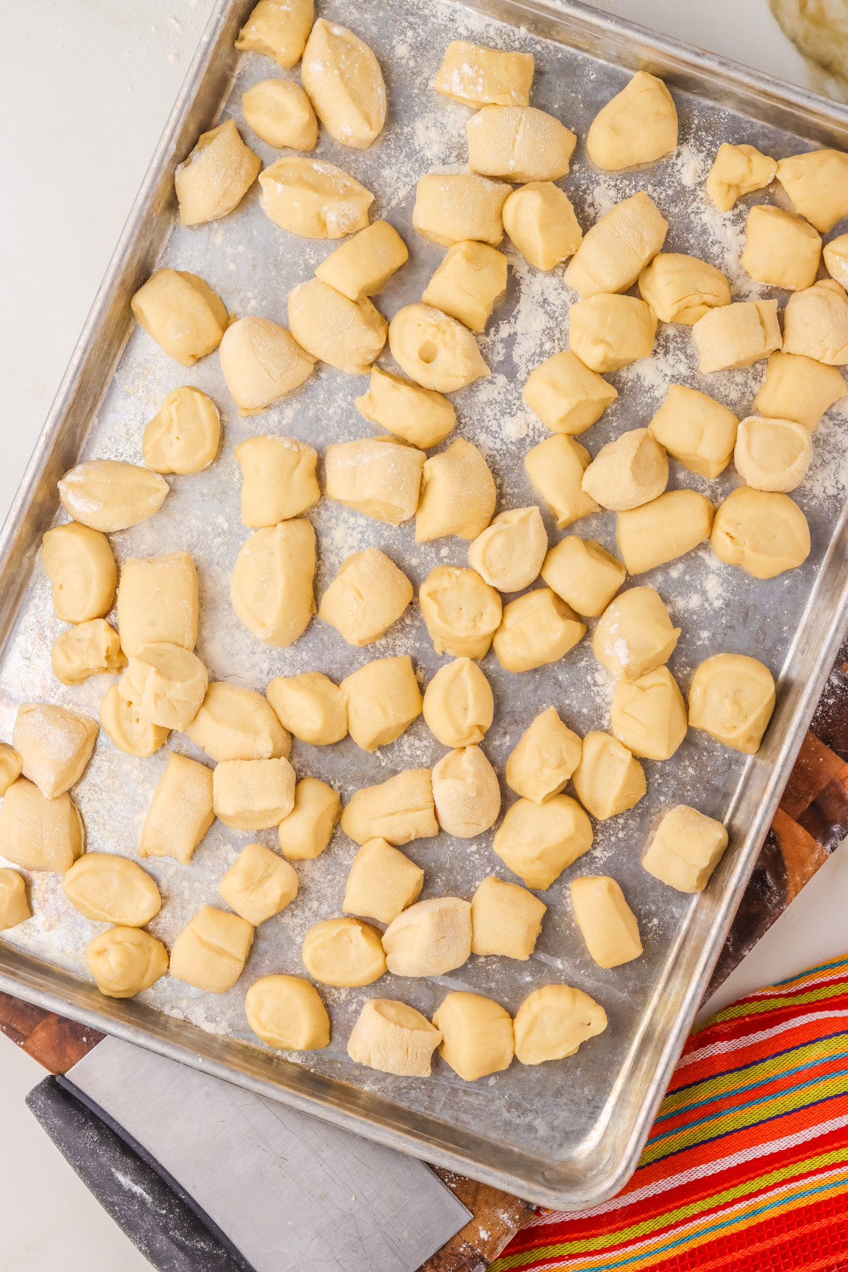 sliced chucks of pretzel doughs. Sliced chucks of pretzel dough on a baking sheet.