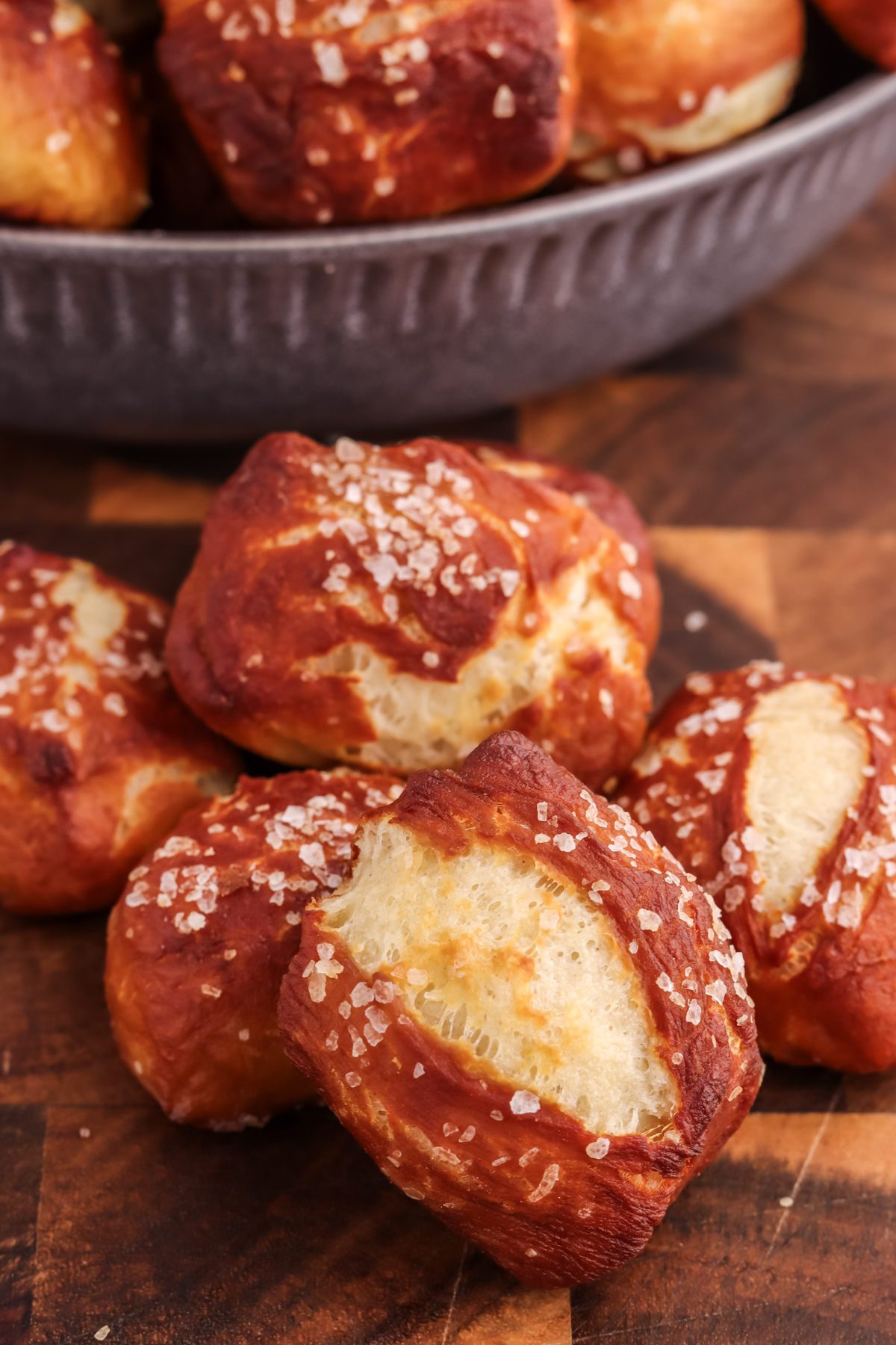 Stacked pretzel bites on a platter. Pretzel bites on a wood platter.