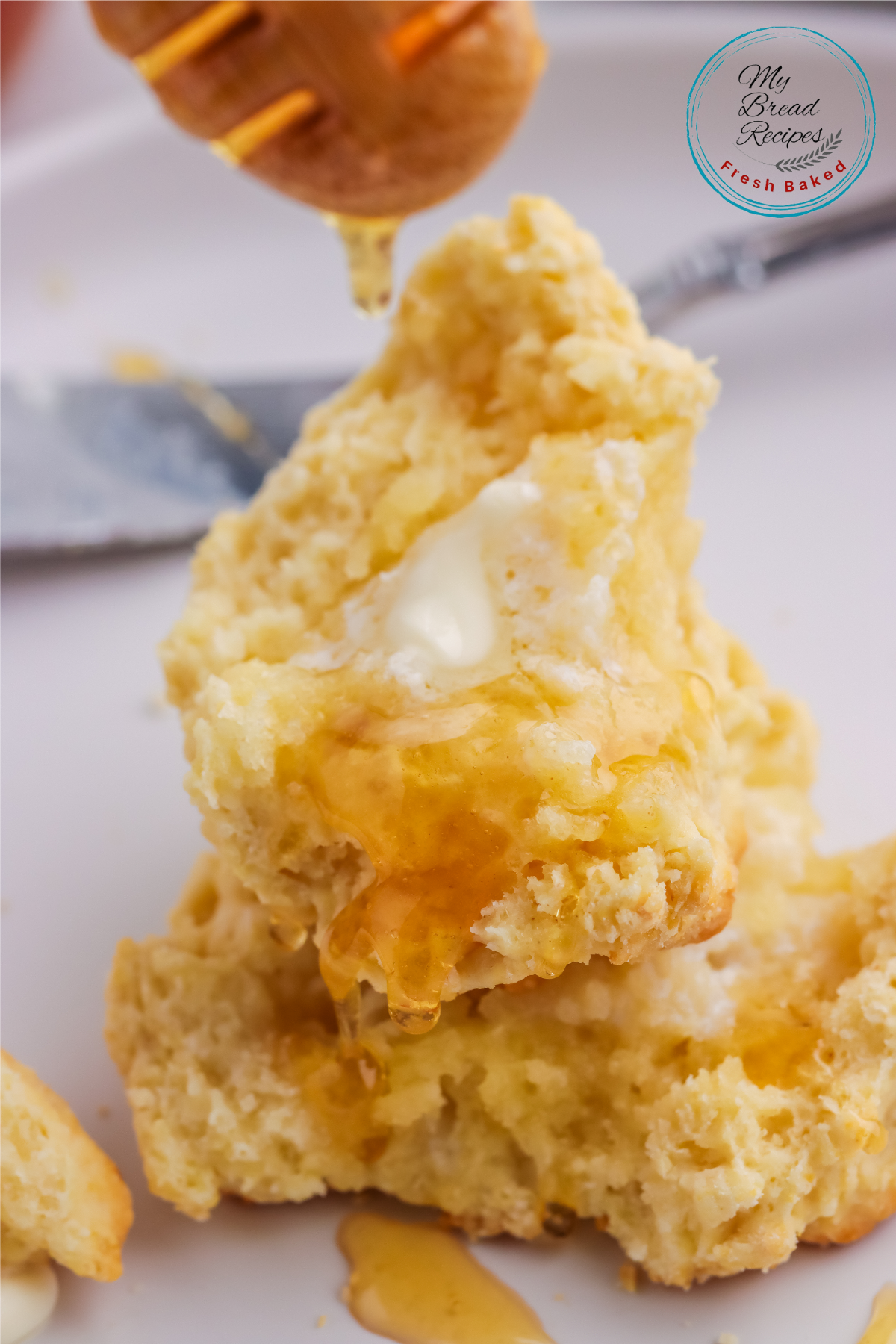 baked drip biscuits with butter and drizzled honey Stacked drop biscuits with honey and butter