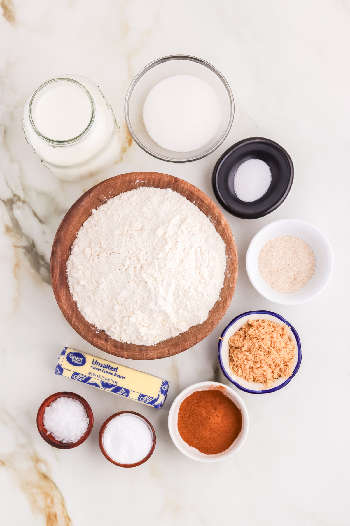 Individual ingredients in individual bowls for cinnamon sugar pretzels.