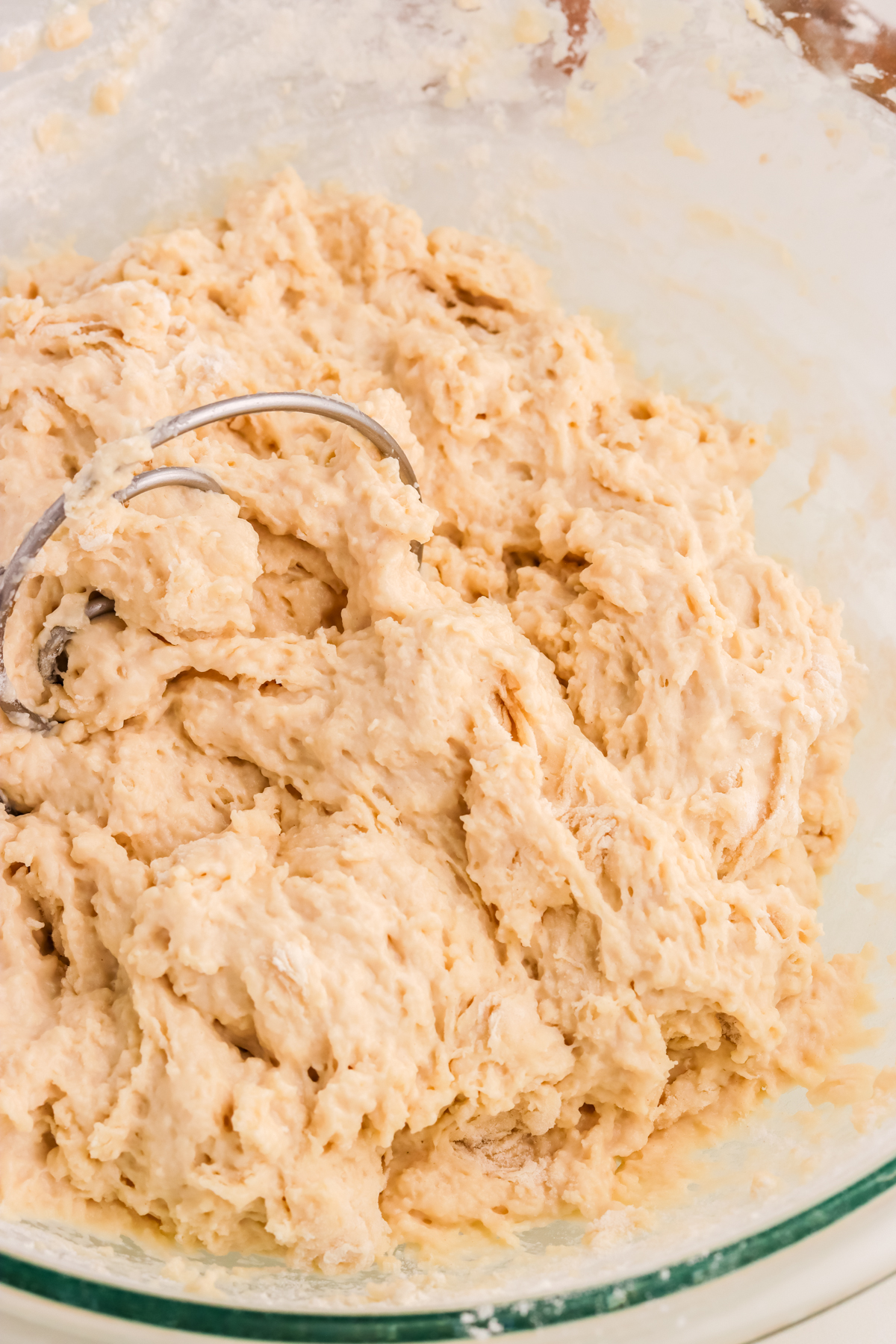 Soft shaggy  pretzel dough mixing in a bowl.