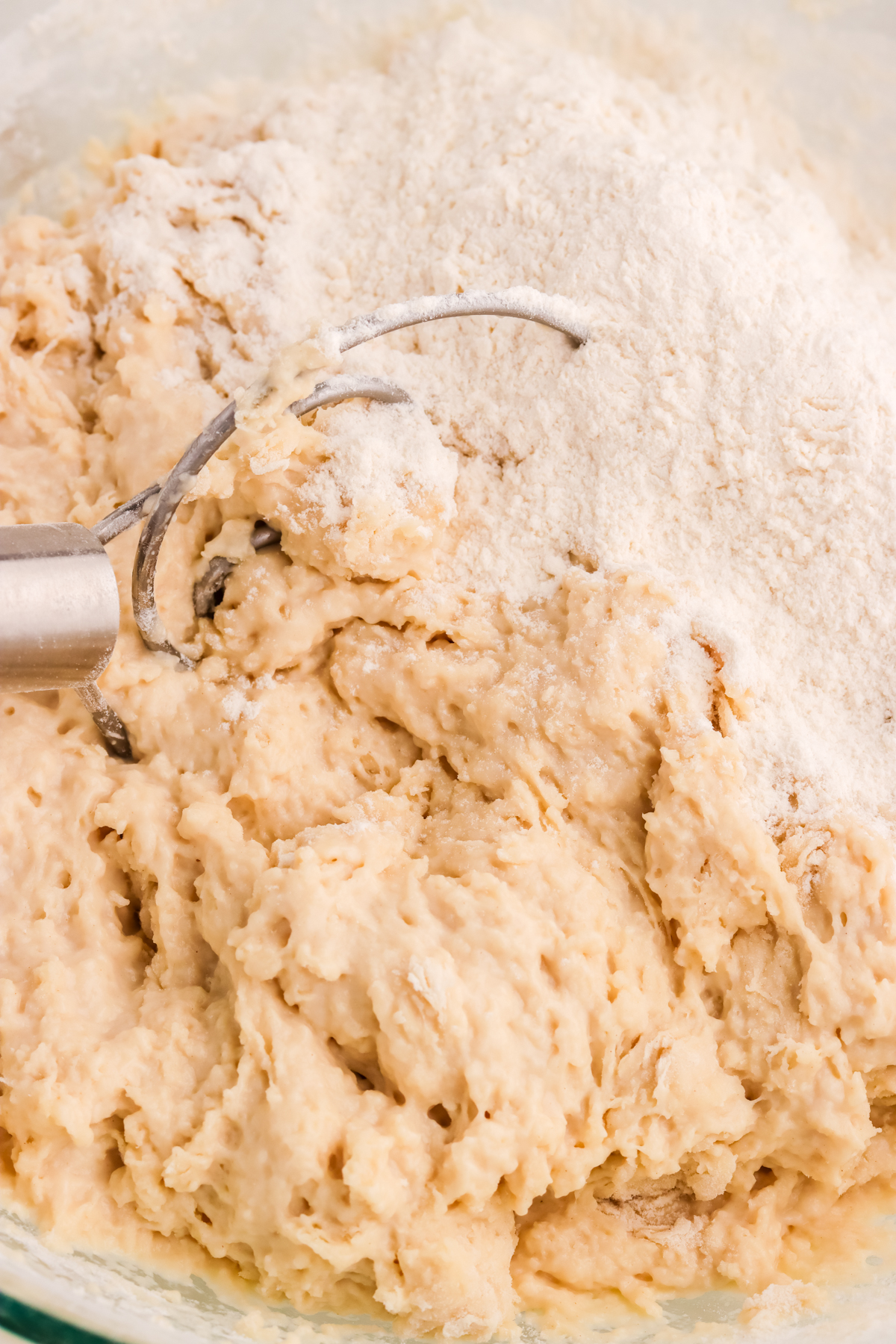 Pretzel dough mixing in a bowl.