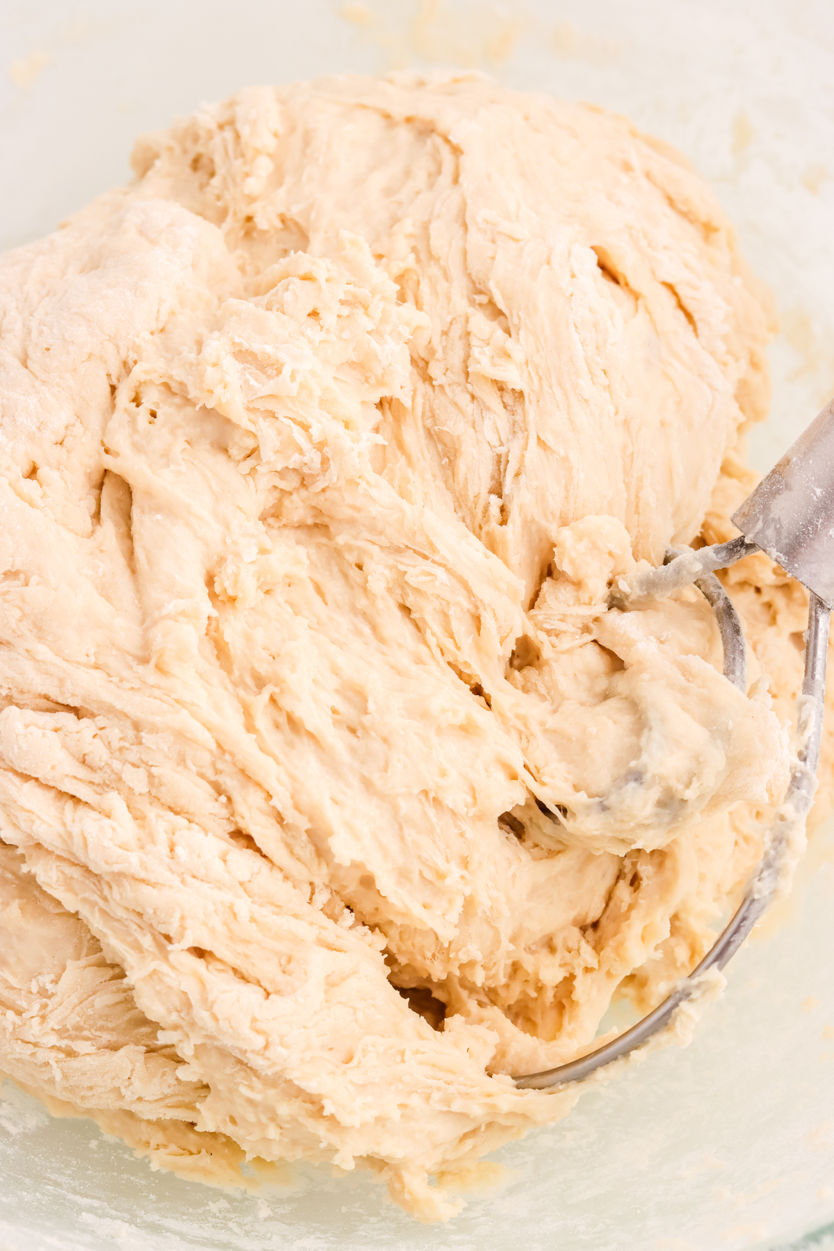 Pretzel dough mixing in a bowl.