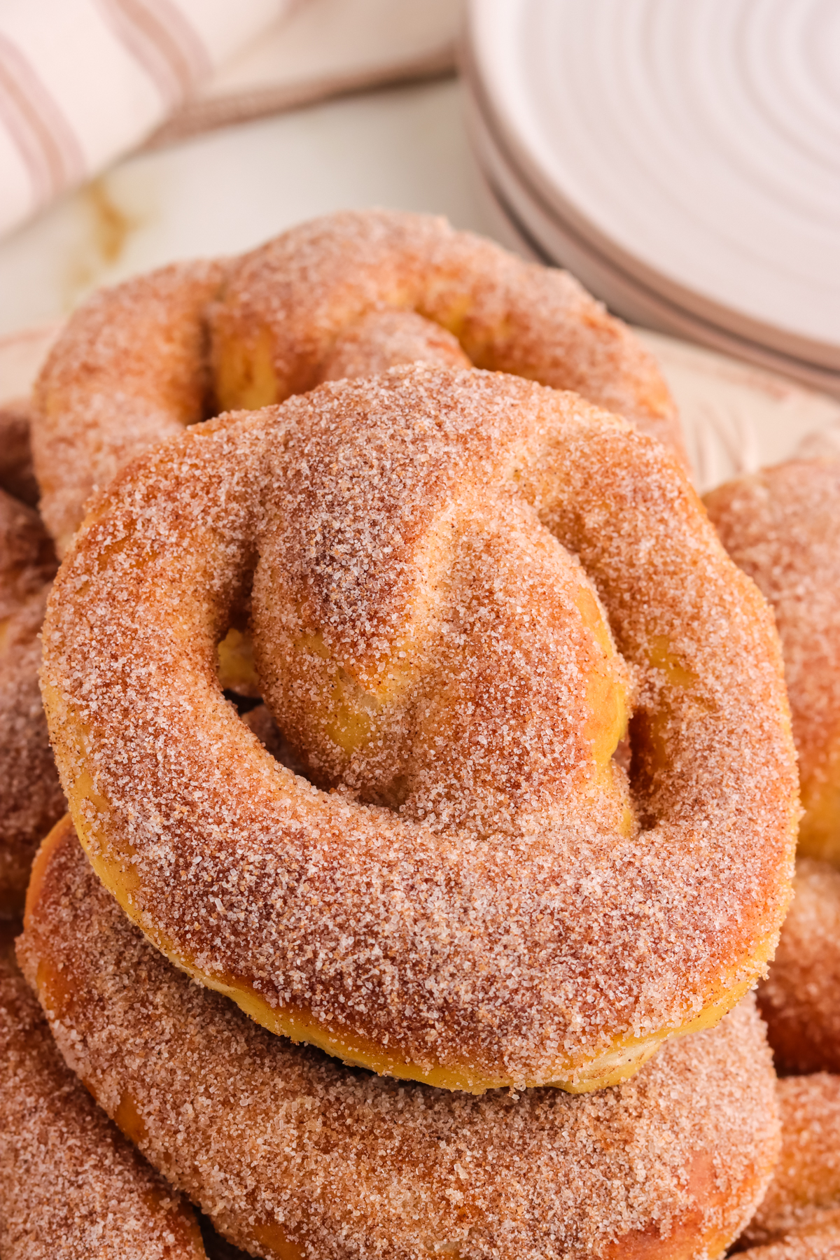 Stacked pretzels coated in cinnamon and sugar.