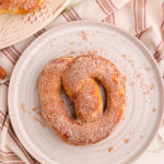 Cinnamon sugar coated pretzel on a white plate